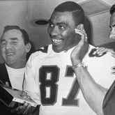 Rankin Smith (right) and coach Norb Hecker (left) join Claude Humphrey in listening to the news of his signing with the Falcons over the radio. (AJC File)