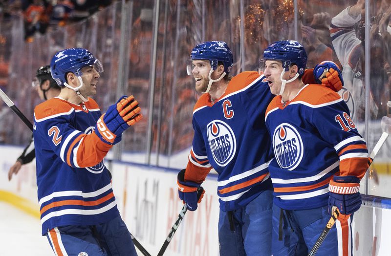 Edmonton Oilers' Evan Bouchard (2), Connor McDavid (97) and Zach Hyman (18) celebrate a goal against the Los Angeles Kings during the second period of Game 2 of an NHL hockey Stanley Cup first-round playoff series Wednesday, April 24, 2024, in Edmonton, Alberta. (Jason Franson/The Canadian Press via AP)