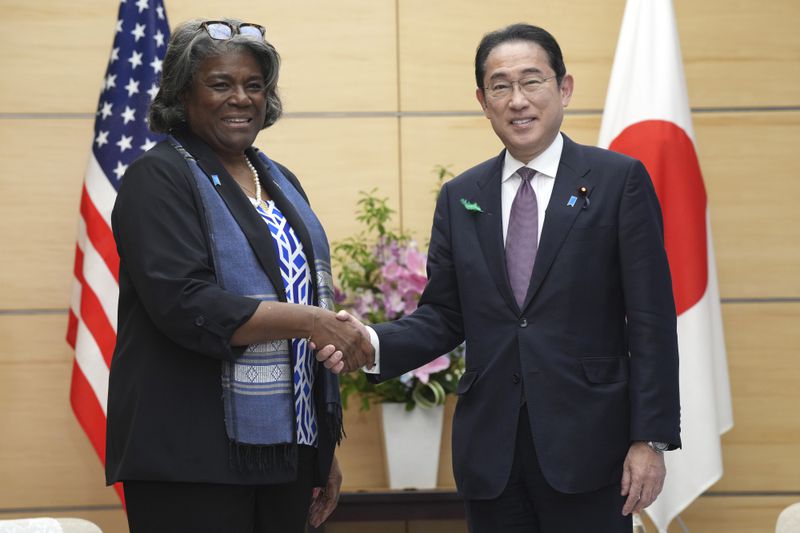 U.S. Ambassador to United Nations Linda Thomas-Greenfield, left, and Japan's Prime Minister Fumio Kishida, right, shake hands during a meeting Friday, April 19, 2024, at prime minister's office in Tokyo. (AP Photo/Eugene Hoshiko, Pool)