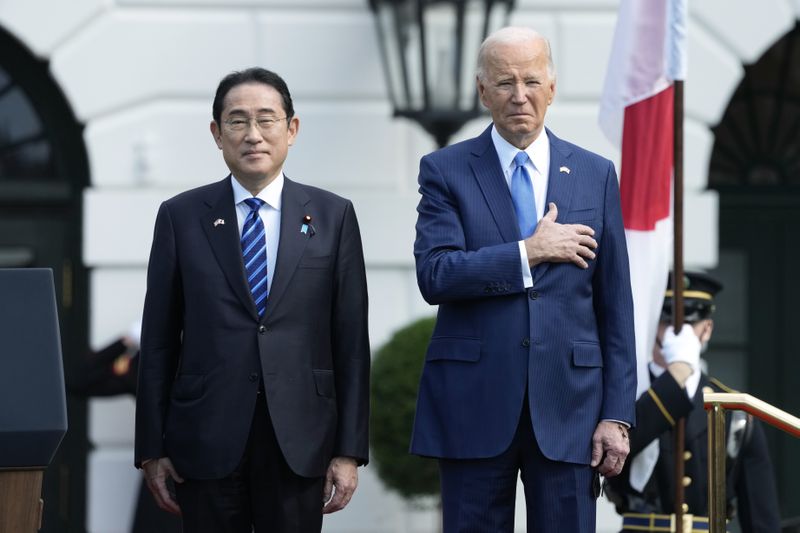 President Joe Biden, right, and Japanese Prime Minister Fumio Kishida stand the U.S. national anthem plays during a State Arrival Ceremony on the South Lawn of the White House, Wednesday, April 10, 2024, in Washington. (AP Photo/Alex Brandon)