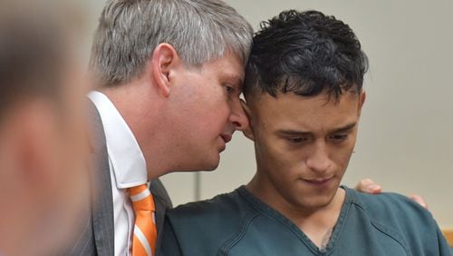 Lawrenceville - Francisco Palencia, 17, and his attorney Scott Smith confer during a hearing in Gwinnett County Magistrate Court at Gwinnett County Detention Center on Friday, July 14, 2017. Josue Ramirez, 19, Francisco Palencia, 17, and Angela Garcia, 18, have been charged with home invasion, rape, aggravated sodomy, kidnapping, aggravated battery and cruelty to children in connection with a May assault. HYOSUB SHIN / HSHIN@AJC.COM