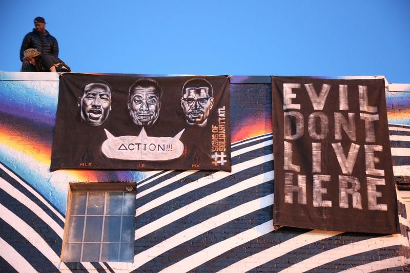 Brandon English created this banner that reads “Evil Don’t Live Here.” Photo: Tim Lampe