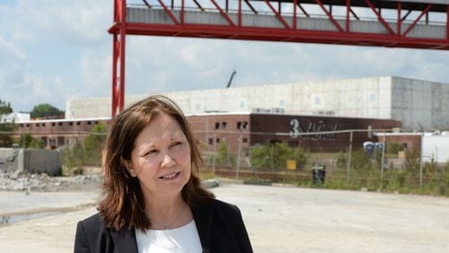 Doraville Mayor Donna Pittman walks through the construction site of Third Rail Studios, one of the first developments at the former General Motors site, Monday, May 2, 2016.