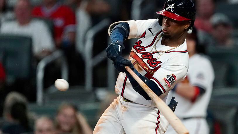 Atlanta Braves' Ozzie Albies hits a single during the third inning of the team's baseball game against the New York Mets on Wednesday, June 30, 2021, in Atlanta. (AP Photo/John Bazemore)