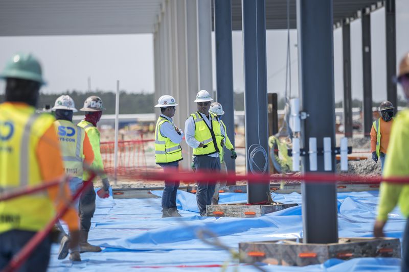 Workers prepare to pour the concrete floor of the assembly building on the Hyundai Metaplant site in Ellabell, Ga., on Monday, July 5, 2023. (Stephen B. Morton for the AJC)