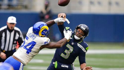 Los Angeles Rams outside linebacker Leonard Floyd (54), a former University of Georgia star, knocks the ball away as Seattle Seahawks quarterback Russell Wilson tries to pass during the first half of an NFL wild-card playoff football game, Saturday, Jan. 9, 2021, in Seattle. (AP Photo/Scott Eklund)