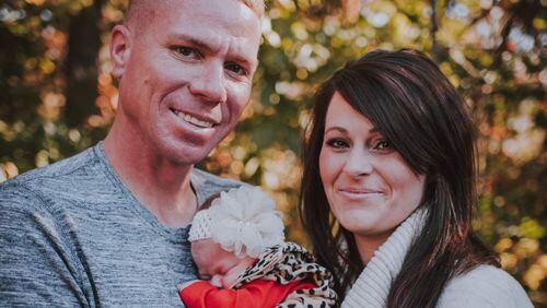 This is a photo of Drue and Kristen Green holding their infant , Emersyn Rose, that was posted on the GoFundMe page for his medical expenses.
