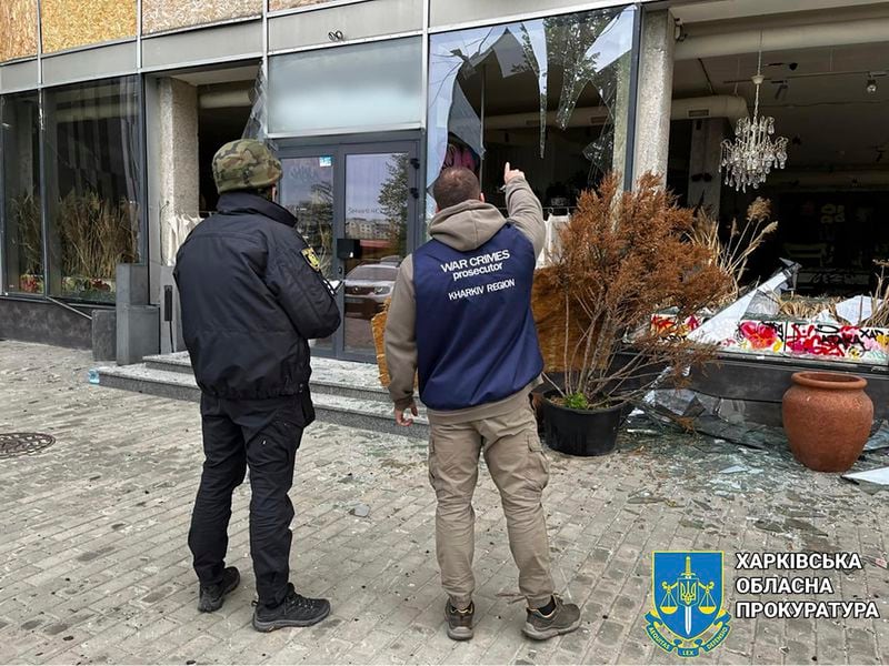 In this photo provided by Kharkiv Regional Prosecutor's Office, war crime prosecutors inspect the scene after Russia's attack in Kharkiv, Ukraine, Wednesday, April 24, 2024. (Kharkiv Regional Prosecutor's Office/ via AP)