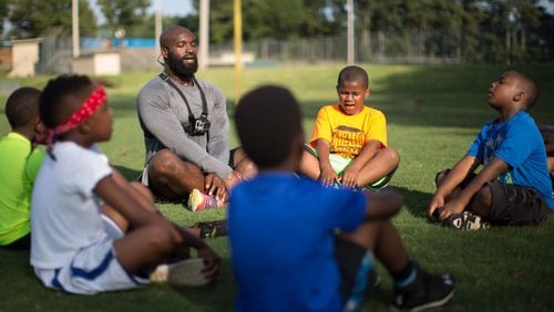 Former NFL player Prince Daniels Jr. leads members of the College Park Rams football team through meditation and breathing exercises in College Park. BRANDEN CAMP / SPECIAL