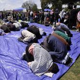Protesters pray at an encampment staged to support the Palestinian cause on the UCLA campus Thursday, April 25, 2024, in Los Angeles. (AP Photo/Jae C. Hong)