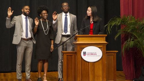 The newly elected administration of the University of Georgia Student Government Association is sworn in during the 31st SGA inauguration at UGA Chapel in Athens, Georgia, on Wednesday, April 4, 2018. The new officers include Treasurer Destin Mizelle, left, Vice President Charlene Marsh, middle, and President Ammishaddai Grand-Jean. (REANN HUBER/REANN.HUBER@AJC.COM)