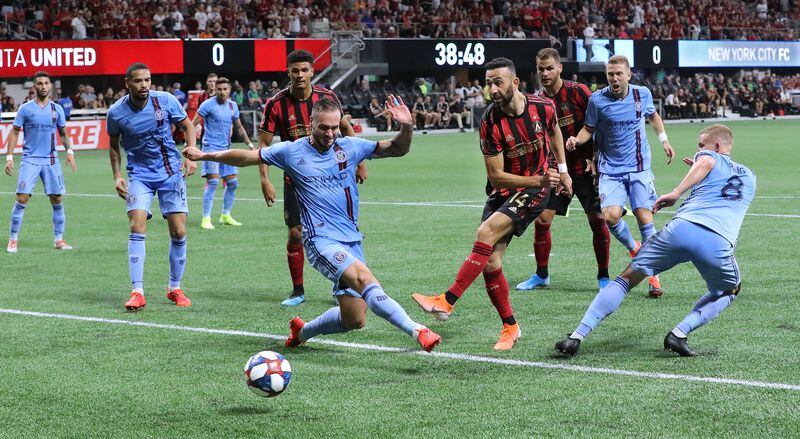 August 11, 2019 Atlanta: Atlanta United midfielder Justin Meram gets off a shot between New York City FC defenders in front of their goal in their soccer match on Sunday, August 11, 2019, in Atlanta.   Curtis Compton/ccompton@ajc.com