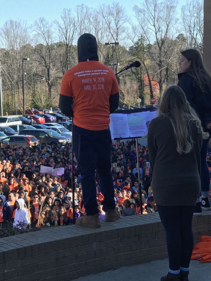 March 14, 2018 -- DeKalb County, Ga. -- During the national student walkout against gun violence Wednesday, a student at Lakeside High School in DeKalb County read the names of the 17 victims shot dead at Marjory Stoneman Douglas High School in Parkland, Fla. on Valentine's Day. His T-shirt reads: “Classes take a pause until Congress passes laws.”