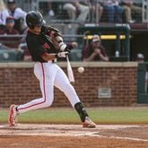 Georgia first baseman and outfielder Charlie Condon (24) connects on his first of three home runs against Texas A&M at Blue Bell Park in College Station, Texas, this past weekend. Condon became the Bulldogs' single-season (29) and career (54) home run leader.  (Kari Hodges/UGA Athletics)