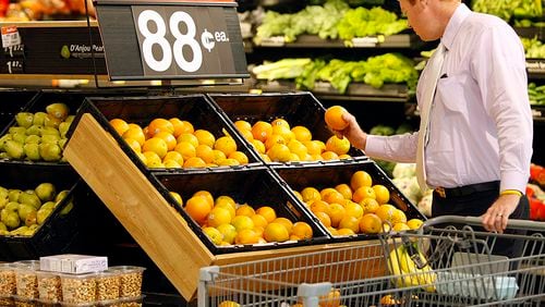John Baber, 31, Marietta, a 10-year grocery shopper at Walmart, picks out fresh produce at the Walmart Supercenter on Cobb Parkway, Marietta, GA, Tuesday, July 22, 2010. CURTIS COMPTON / ccompton@ajc.com