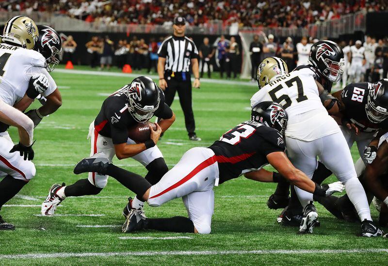 Falcons quarterback Marcus Mariota follows a block by guard Chris Lindstrom into the end zone on a quarterback keeper for a 23-10 lead over the New Orleans Saints during the third quarter in a NFL football game on Sunday, Sept. 11, 2022, in Atlanta.   “Curtis Compton / Curtis Compton@ajc.com