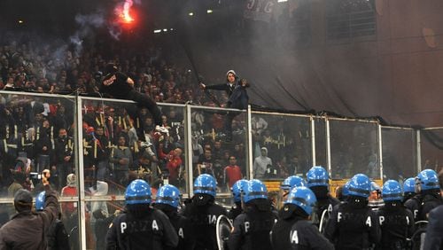 Police in riot gear confront Serbia fans  during a match between Italy and Serbia in Genoa, Italy. (Valerio Pennicino/Getty Images)