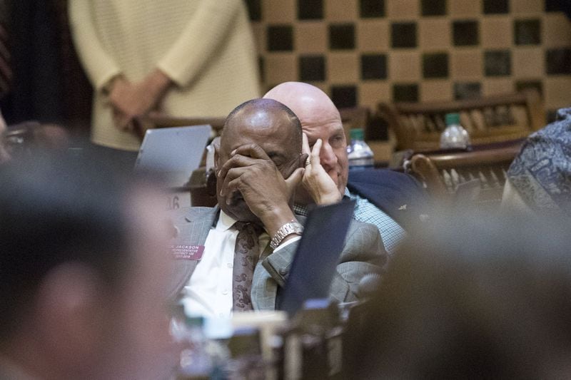 State Rep. Derrick Jackson, R-Tyrone, covers his face in the House chamber Wednesday during Crossover Day at the Georgia State Capitol in Atlanta. ALYSSA POINTER/ALYSSA.POINTER@AJC.COM