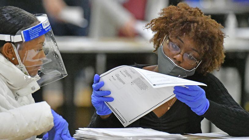 A team works on a hand recount and audit of ballots in Fulton County at the Georgia World Congress Center in November 2020. (Hyosub Shin / Hyosub.Shin@ajc.com)
