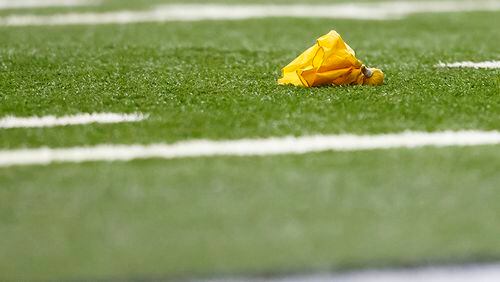 Penalty flag is seen on the field during an NFL football game between the Detroit Lions and the Arizona Cardinals at Ford Field in Detroit, Sunday, Oct. 11, 2015. (AP Photo/Rick Osentoski)