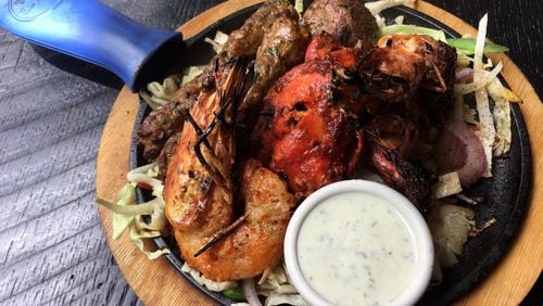The tandoori mixed grill at Blue India comes loaded with king prawns, chicken, and two kinds of lamb kebab. CONTRIBUTED BY WYATT WILLIAMS