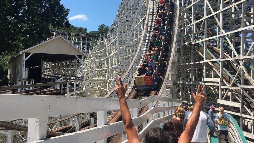 Parkgoers take one last ride on the Georgia Cyclone before it closed on Sunday, July 30. AJC/Greg Bluestein