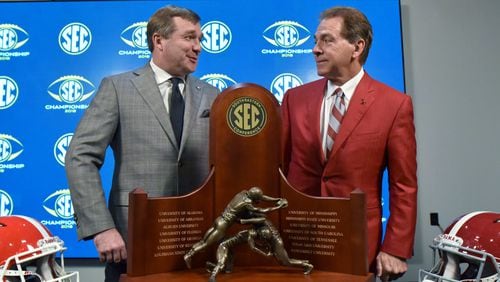 Georgia Head Coach Kirby Smart and Alabama Head Coach Nick Saba pose in front of the Championship Trophy during a SEC press conference at Mercedes-Benz Stadium on Friday, November 30, 2018. HYOSUB SHIN / HSHIN@AJC.COM