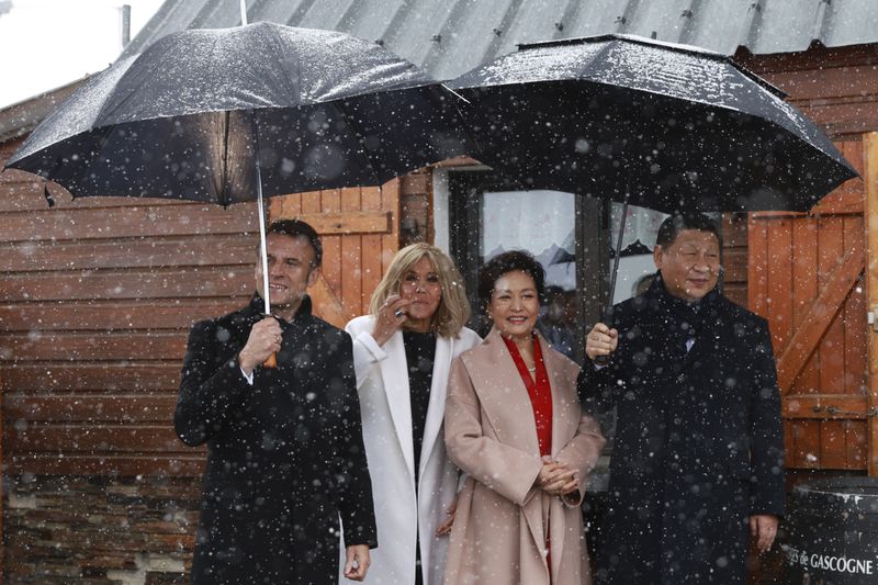 French President Emmanuel Macron and his wife Brigitte Macron, Chinese President Xi Jinping, and his wife Peng Liyuan watch folklore dancers, Tuesday, May 7, 2024 at the Tourmalet pass, in the Pyrenees moutains. French president is hosting China's leader at a remote mountain pass in the Pyrenees for private meetings, after a high-stakes state visit in Paris dominated by trade disputes and Russia's war in Ukraine. French President Emmanuel Macron made a point of inviting Chinese President Xi Jinping to the Tourmalet Pass near the Spanish border, where Macron spent time as a child visiting his grandmother. (AP Photo/Aurelien Morissard, Pool)