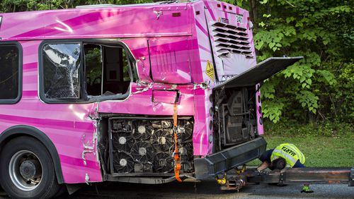 The MARTA bus that collided with a train near the intersection of Welcome All Road and Southmeadow Parkway West in East Point is lifted onto the arm of a wrecker on Wednesday, May 13, 2015. JONATHAN PHILLIPS / SPECIAL