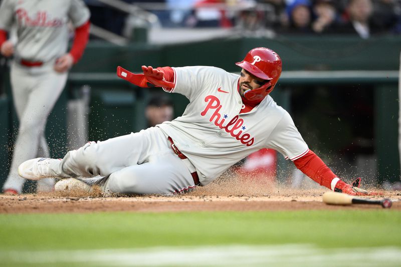Philadelphia Phillies'Nick Castellanos slides home to score on a single by Kyle Schwarber during the second inning of a baseball game against the Washington Nationals, Friday, April 5, 2024, in Washington. (AP Photo/Nick Wass)