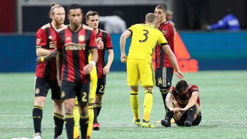Columbus Crew defender Josh Williams consoles Atlanta United's Hector Villalba after Atlanta was eliminated in a shoot-out of the first round of the MLS playoffs.