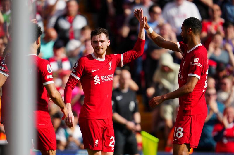 Liverpool's Andrew Robertson, center, is congratulated after scoring his side's 2nd goal during the English Premier League soccer match between Liverpool and Tottenham Hotspur at Anfield Stadium in Liverpool, England, Sunday, May 5, 2024. (AP Photo/Jon Super)