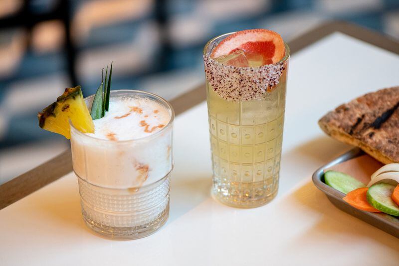 The HIlton (left) with rum, coconut, pineapple, lime, and Anessette, and The Tzuk (right) with spicy tequila, grapefruit, and fresh herbs. Photo credit- Mia Yakel.