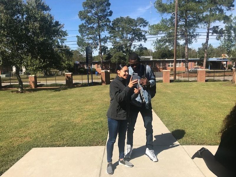 Fort Valley State University students Keila Outen, 23, and Joseph Cornick, 22, share a laugh as they look at her smartphone in this 2018 file photo.
