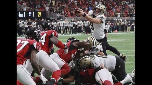 New Orleans Saints quarterback Drew Brees goes over the top for the winning touchdown in overtime to beat the Atlanta Falcons 43-37 in an NFL football game, on Sunday, Sept 23, 2018, in Atlanta. (Curtis Compton/Atlanta Journal-Constitution)