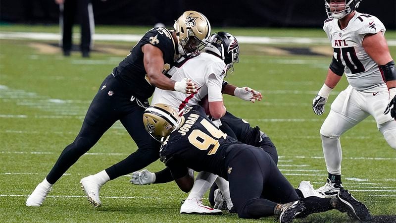 Falcons quarterback Matt Ryan is sacked by Saints defensive ends Cameron Jordan (94) and Marcus Davenport, pushing the Flacons out of field goal range, in the first half Sunday, Nov. 22, 2020, in New Orleans. (Butch Dill/AP)