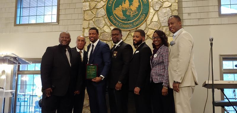 Chris Tucker poses with members of the Stockbridge City Council.