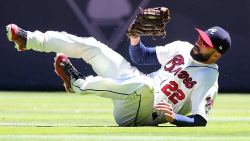 Braves outfielder Nick Markakis makes a sliding catch during Sunday's game at SunTrust Park.