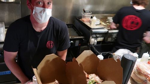 Corban Irby, owner of OK Yaki, prepares meals for takeout at 97 Estoria in Cabbagetown. CONTRIBUTED BY CALEB IRBY