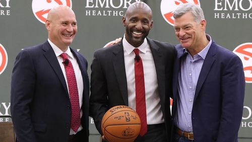 The Atlanta Hawks general manager Travis Schlenk (left) and owner Tony Ressler (right) introduce Lloyd Pierce as the 13th full-time coach in the Atlanta history of the NBA basketball franchise on Monday, May 14, 2018, in Atlanta. Pierce joins the Hawks after spending the past five seasons as an assistant coach with the 76ers. He also spent time with the Cavaliers, Warriors and Grizzlies organizations.   Curtis Compton/ccompton@ajc.com