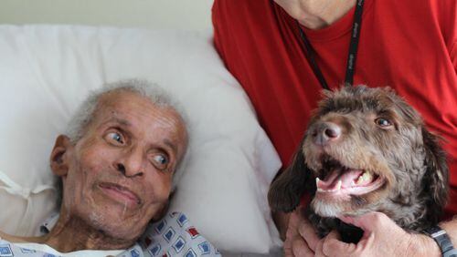 Willie Hill, a veteran of the Korean War and resident of Scepter nursing facility, get a visit from Jerry Wilson and his labradoodle, Rascal. CONTRIBUTED