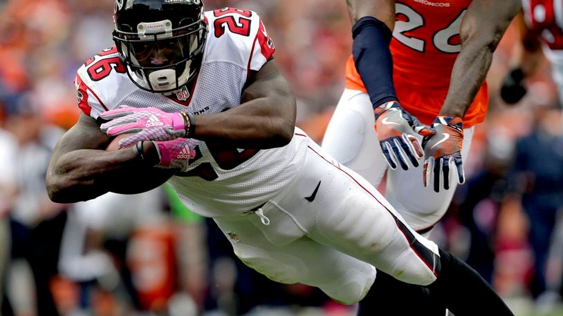 Atlanta Falcons running back Tevin Coleman (26) dives into the end zone for a touchdown against the Denver Broncos during the second half of an NFL football game, Sunday, Oct. 9, 2016, in Denver. (AP Photo/Joe Mahoney)