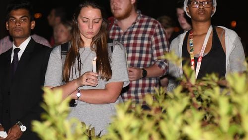 Friends embrace during the vigil in memory of Georgia Tech student Scout Schultz, one of 30 Georgians shot and killed by police in 2017. Schultz was suicidal. Roughly a quarter of 2017 shootings involved mental illness. REBECCA BREYER
