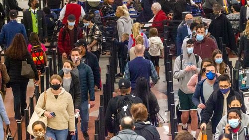 Travelers go through security at Hartsfield-Jackson Atlanta International Airport Sunday, November 21, 2021. STEVE SCHAEFER FOR THE ATLANTA JOURNAL-CONSTITUTION