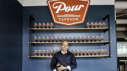 “People can come here and sample all the cool new stuff in one place,” says Atlanta Pour Taproom owner Ray Ballester, shown at the host stand. CONTRIBUTED BY LAUREN VEREEN / SALUT MEDIA