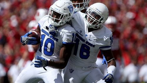 Chandon Sullivan (10) and Penny Hart of Georgia State celebrate after Sullivan made an interception against Wisconsin in the fourth quarter Sept. 17. (Dylan Buell/Getty Images)