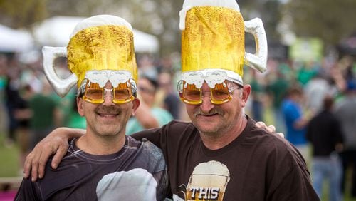 Justin Lester (L) and Scott George show of there beer fest hats at the Suwanee Beer Fest in Suwanee. STEVE SCHAEFER / SPECIAL TO THE AJC