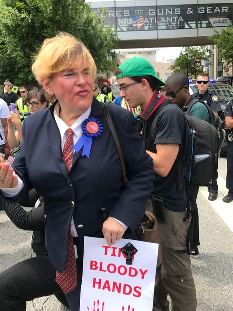 Priscilla Smith, aka "the real Donna J. Trump," joined protesters demonstrating against the president, who was in Atlanta to deliver a speech at the National Rifle Association convention. Smith is now running as a Democrat for the Georgia House.