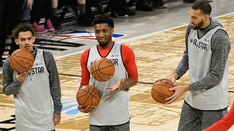 Trae Young of the Hawks, left, Donovan Mitchell of the Jazz, center, and Rudy Gobert of the Jazz, right, warm up during an NBA All-Star practice Saturday, Feb. 15, 2020, in Chicago. (AP Photo/David Banks)