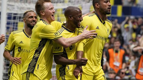 Nashville SC midfielder Dax McCarty, second from left, and midfielder Fafà Picault, center, congratulate forward Teal Bunbury after his goal against Atlanta United during the second half of an MLS soccer match on Saturday, April 29, 2023, in Nashville, Tenn. (AP Photo/George Walker IV)